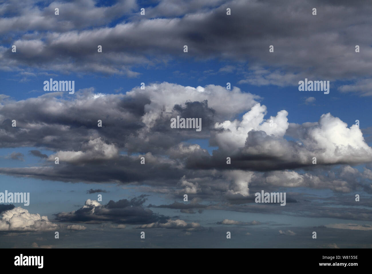 White cumulus cloud, grey clouds, blue sky Stock Photo