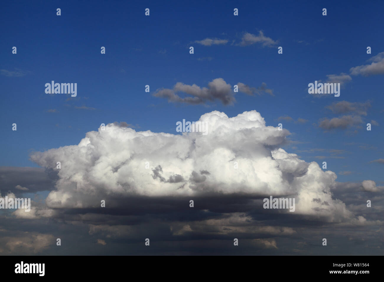 White cumulus cloud, grey clouds, blue sky Stock Photo