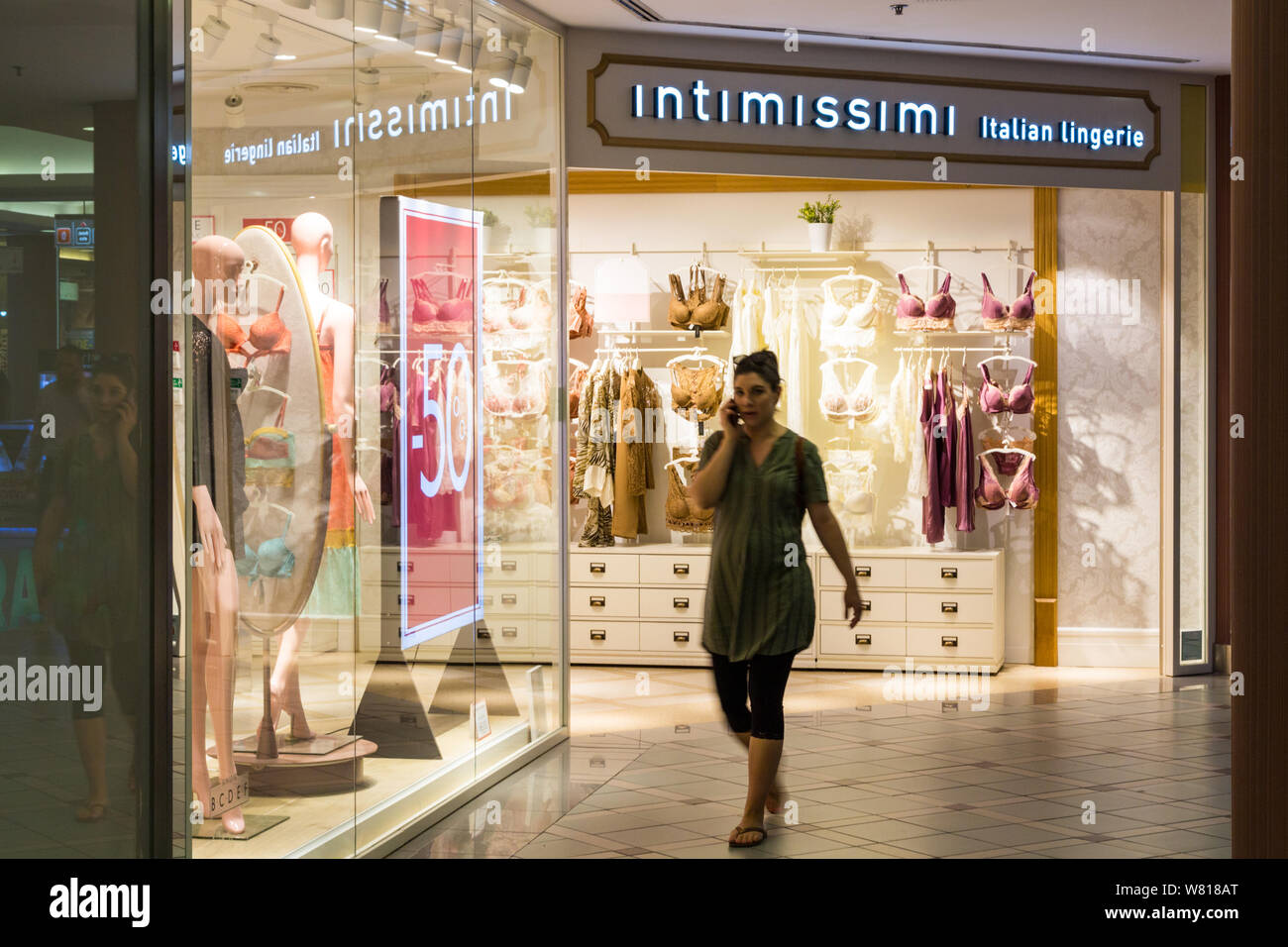 Intimissimi shop front with walking phoning young woman in Mammut shopping  center, Budapest, Hungary Stock Photo - Alamy