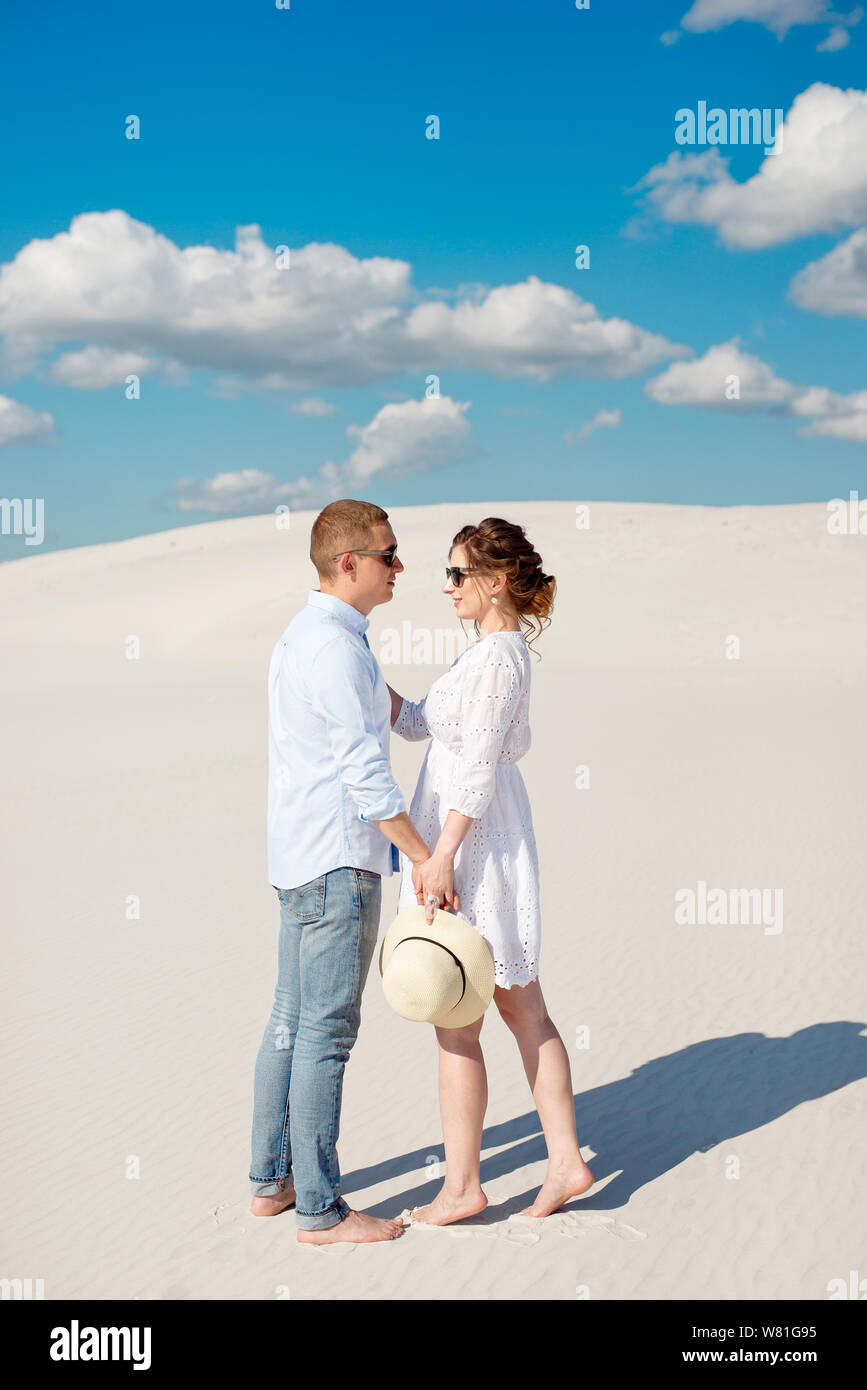 Young Couple Enjoying The Sunset In The Dunes Romantic Traveler Young Couple Enjoying The Sunset In The Dunes Romantic Traveler