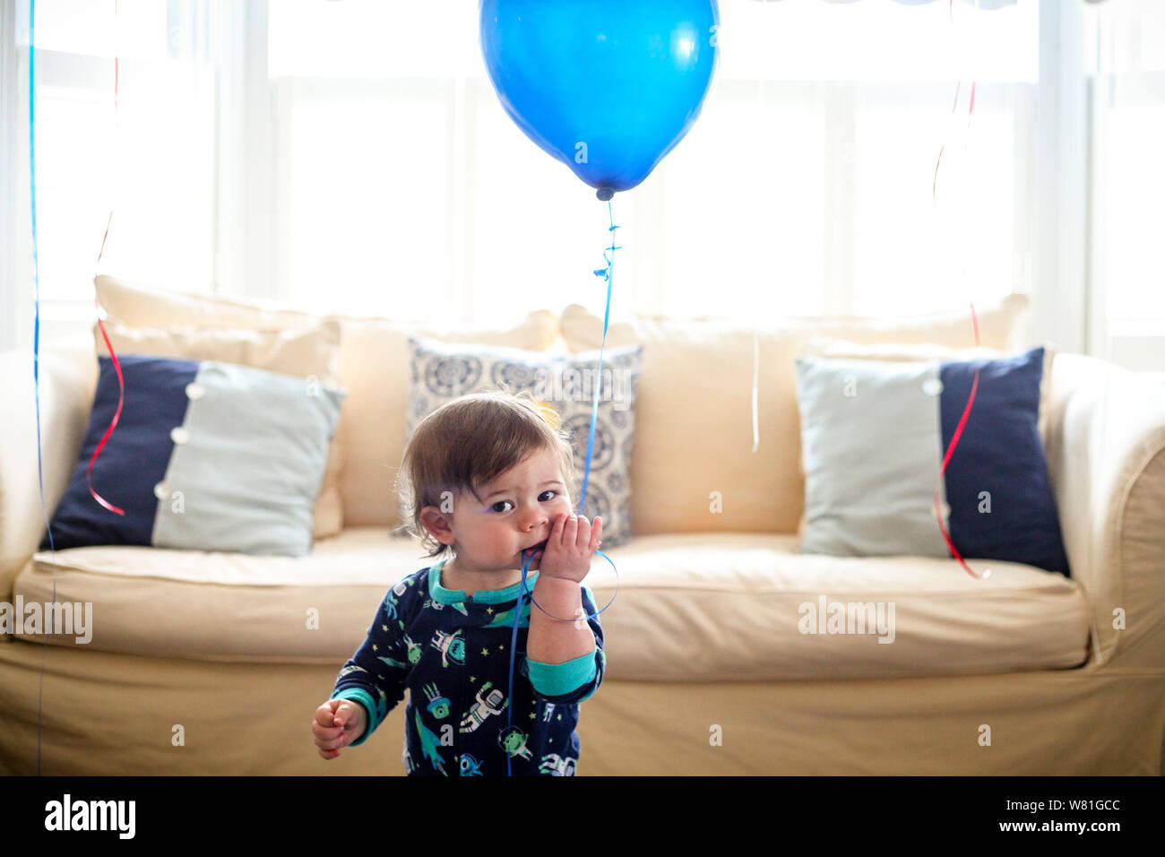Infant Boy Holding Blue Balloon Stock Photo
