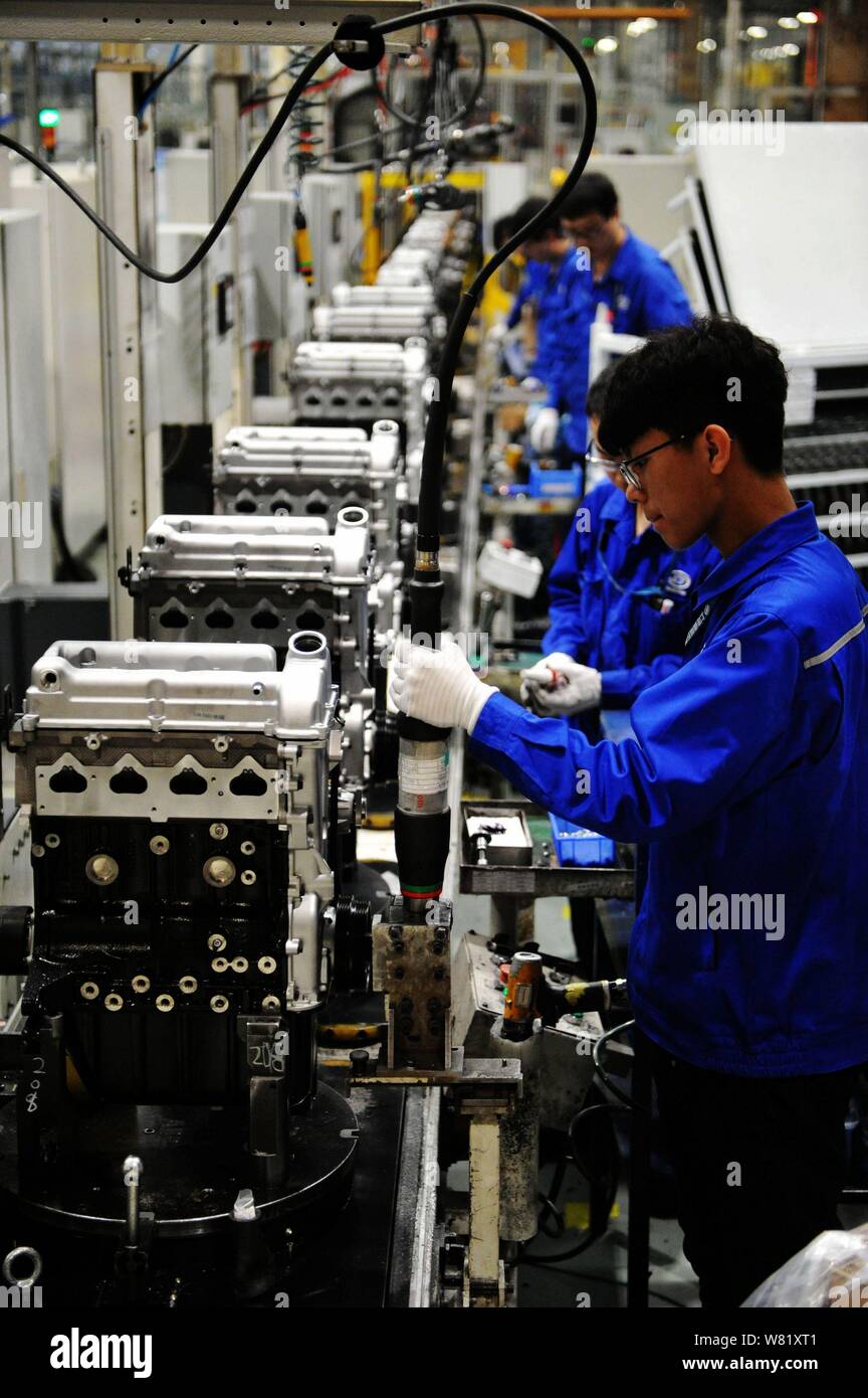 Chinese workers assemble cars on the assembly line at an auto plant of ...