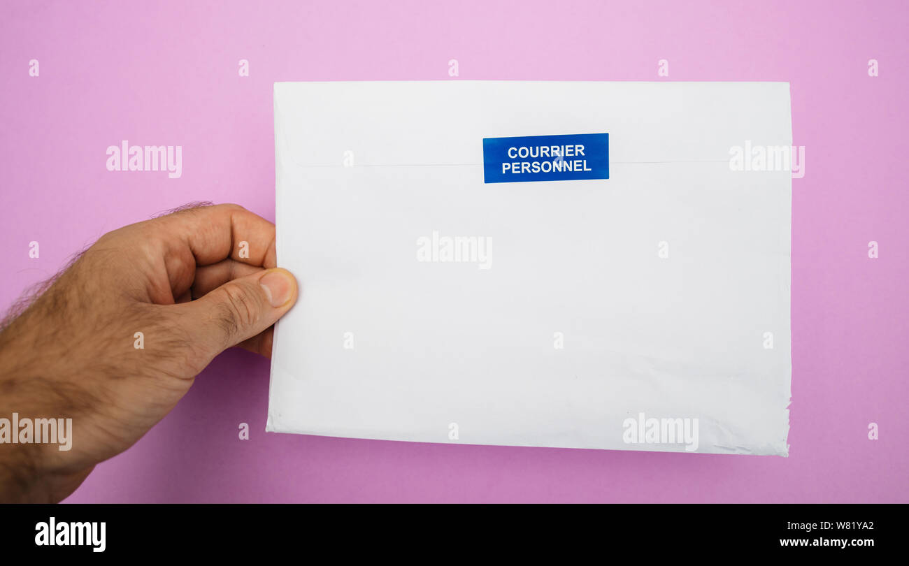 Man hand holding envelope with Courrier Personnel Personal Mail sign  sticker Stock Photo - Alamy