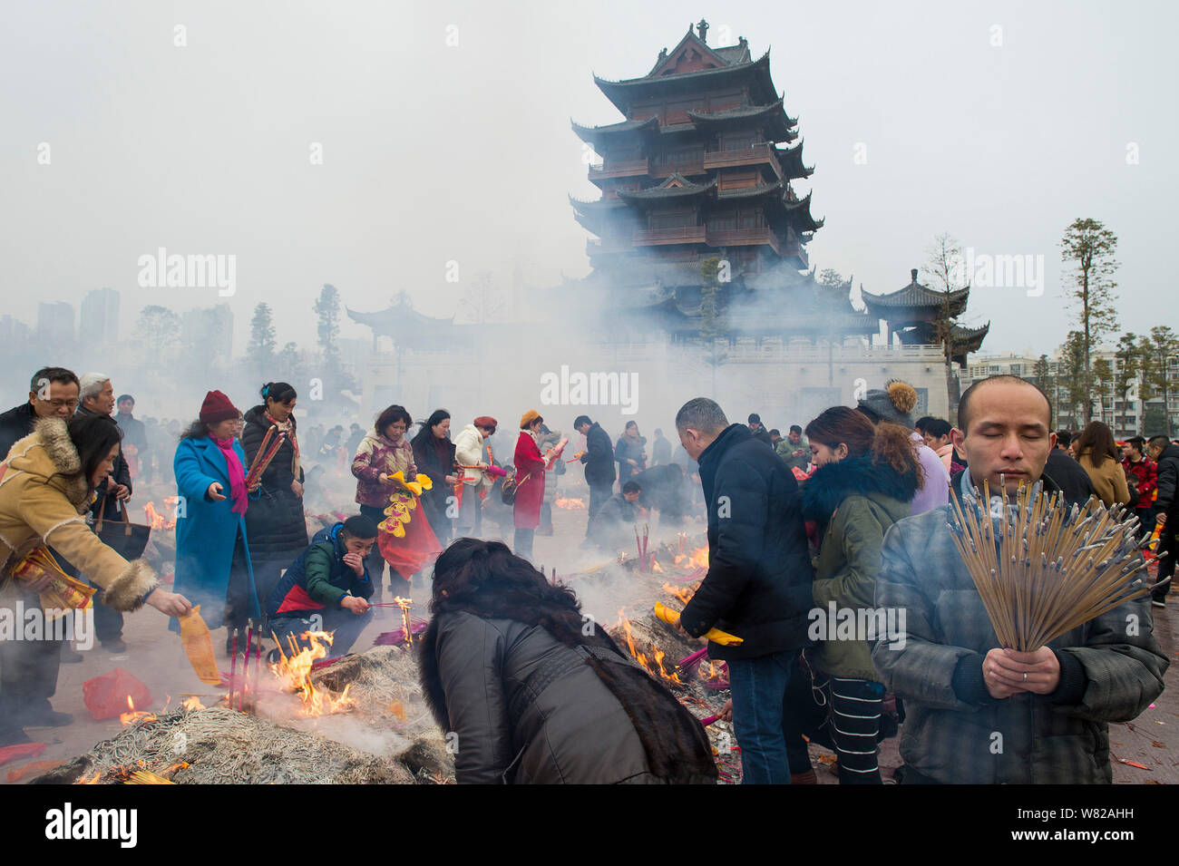 Chinese worshippers burn incense sticks to pray for wealth and