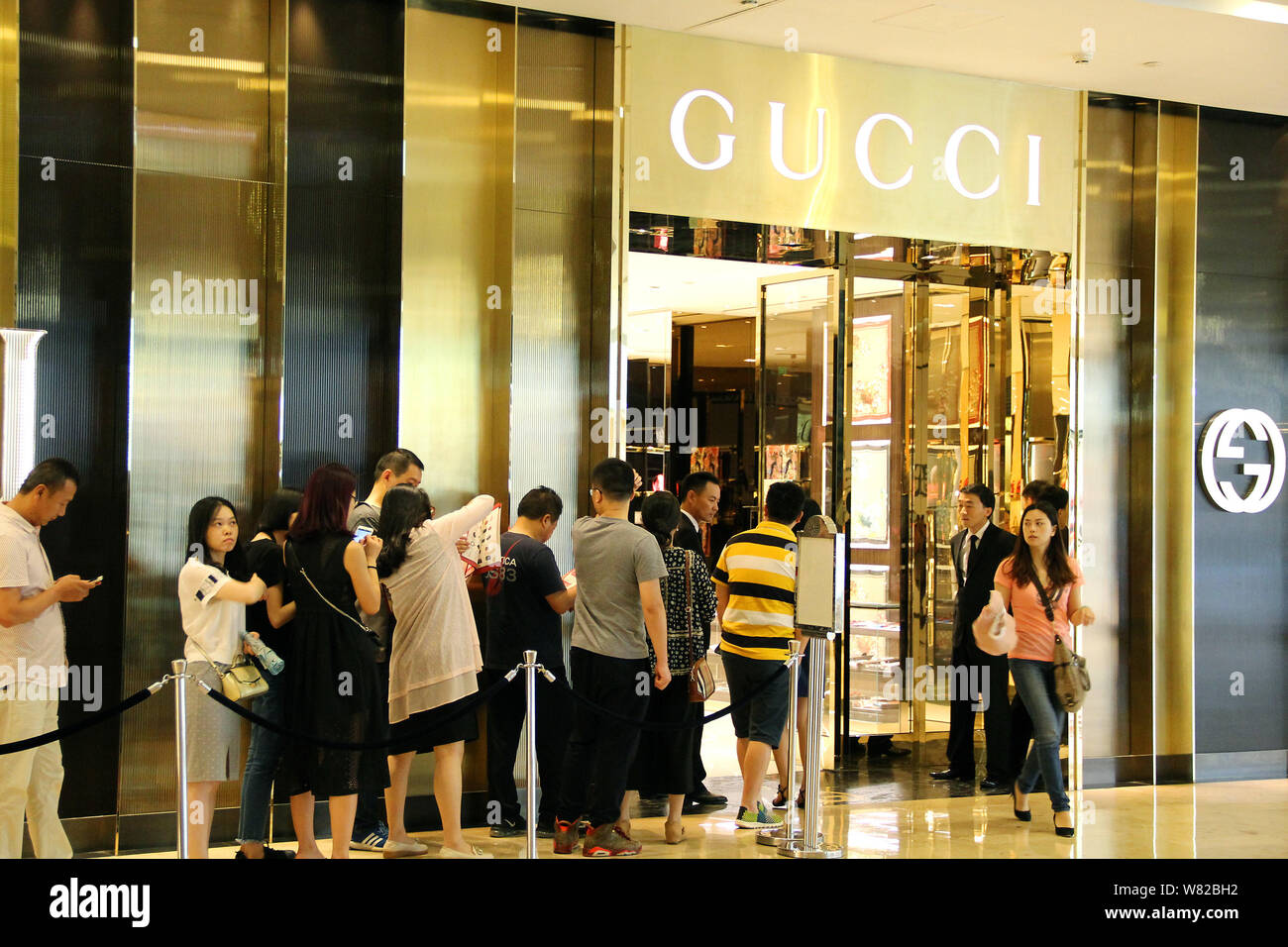 FILE--Chinese customers queue up outside a fashion boutique of
