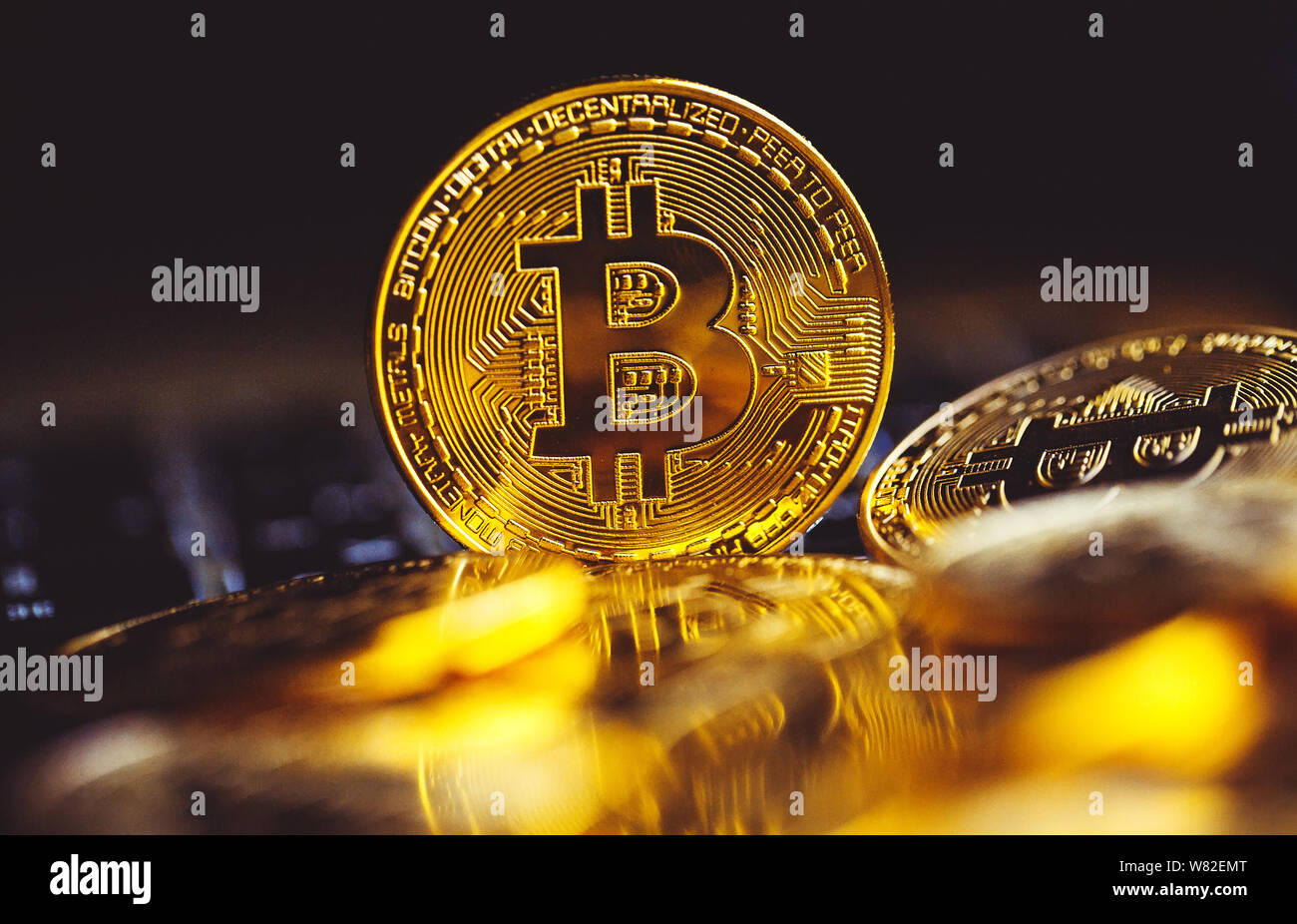 Bitcoin coins on laptop keyboard. Cryptocurrency concept. Stock Photo
