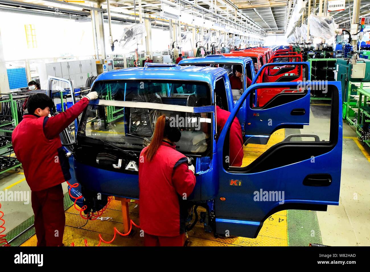 --FILE--Chinese workers assemble trucks on the assembly line at an auto ...