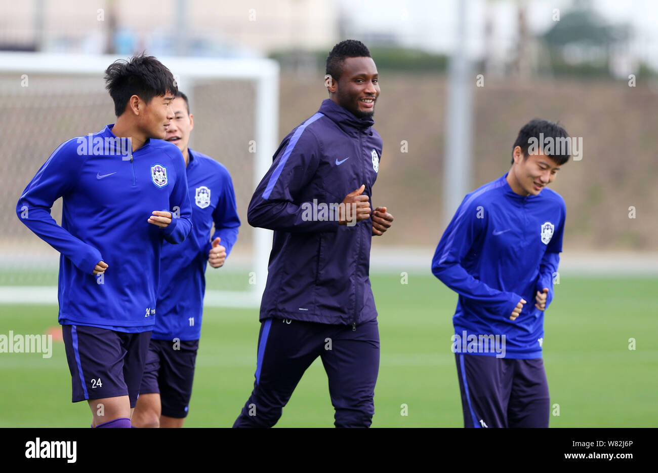Nigerian football player John Obi Mikel, center, and other players of Tianjin TEDA F.C. take part in a training session in Okinawa, Japan, 15 February Stock Photo