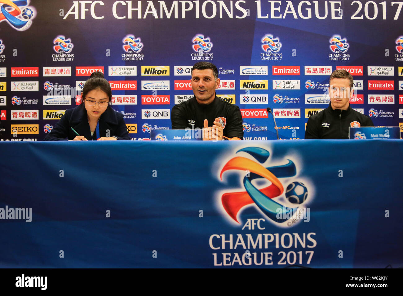 Head coach John Aloisi, center, and Matt McKay, right, of Brisbane Roar FC attend a press conference before a qualifying match against Shanghai Greenl Stock Photo