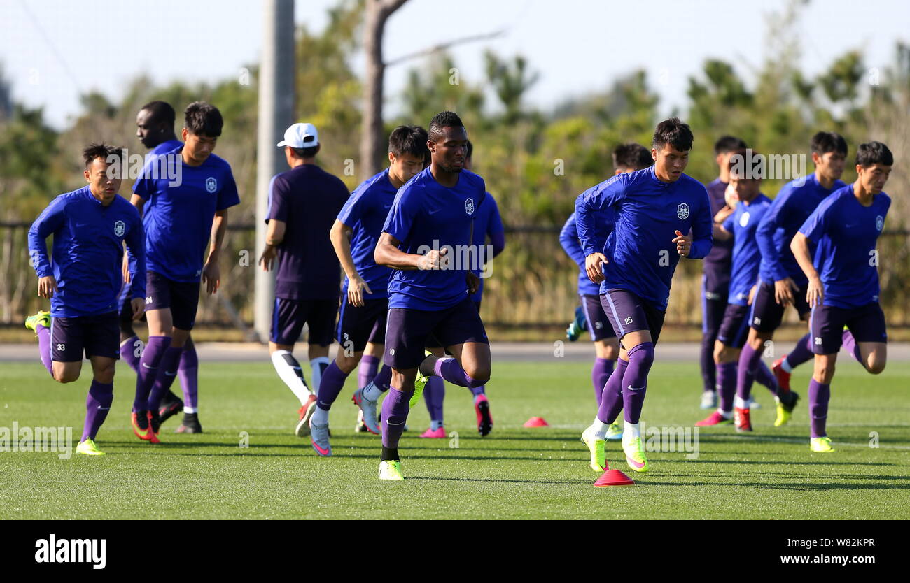 Nigerian football player John Obi Mikel, center, and other players of Tianjin TEDA F.C. take part in a training session in Okinawa, Japan, 16 February Stock Photo