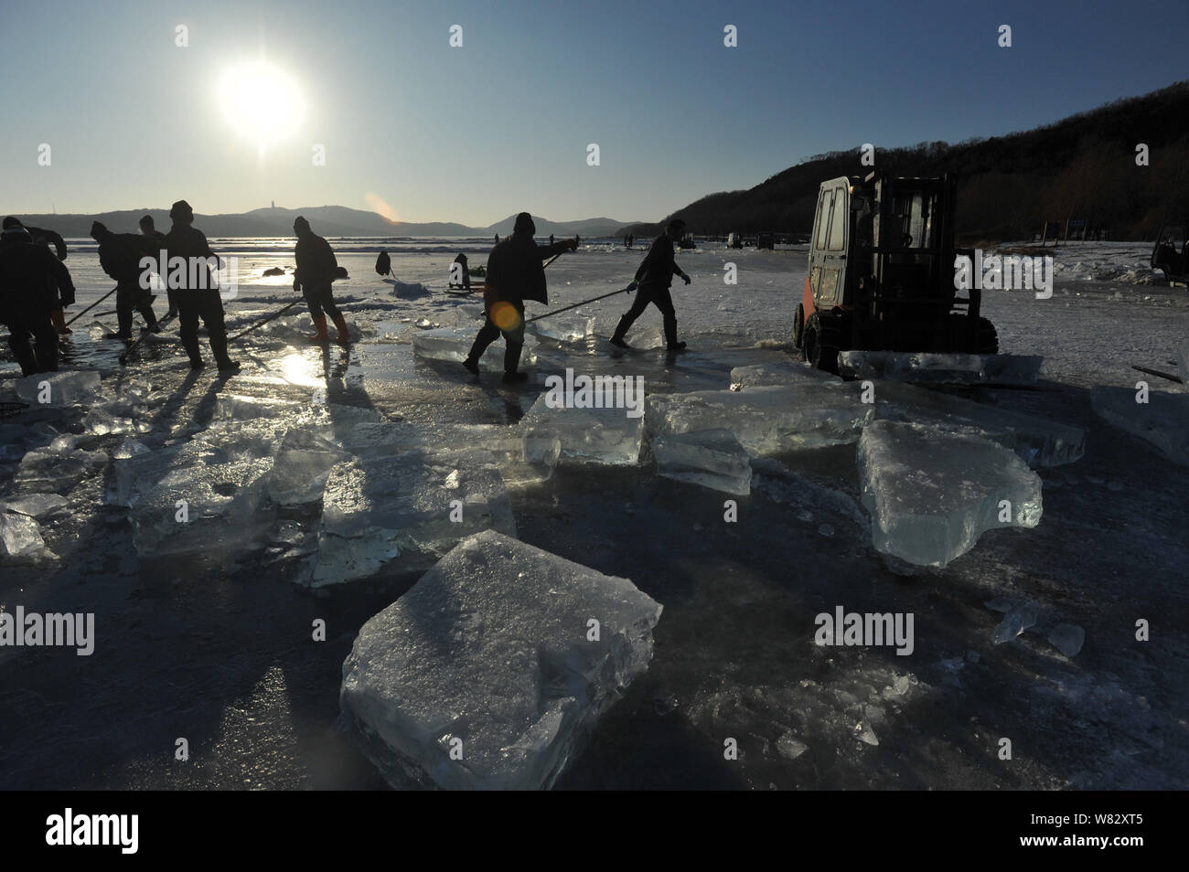Chinese workers chisel the frozen Xiuhu Lake in Qipan Mountain to ...