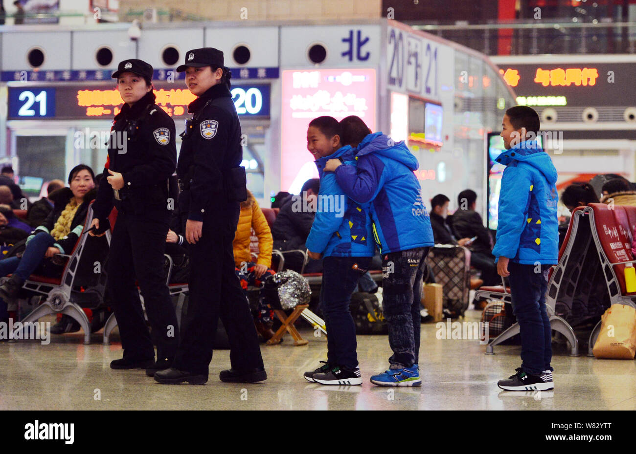 Young Chinese boys 'patrol' the Shijiazhuang Railway Station as they go back home with their parents for the upcoming Chinese Lunar New Year, also kno Stock Photo