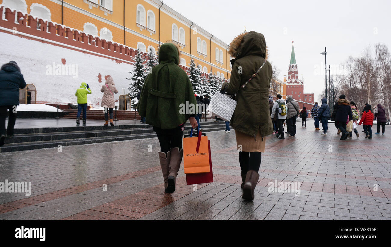 Chinese tourists carrying shopping bags of Louis Vuitton (LV) and Furla  visit a scenic spot with others as they travel abroad in Moscow, Russia, 16  Ja Stock Photo - Alamy