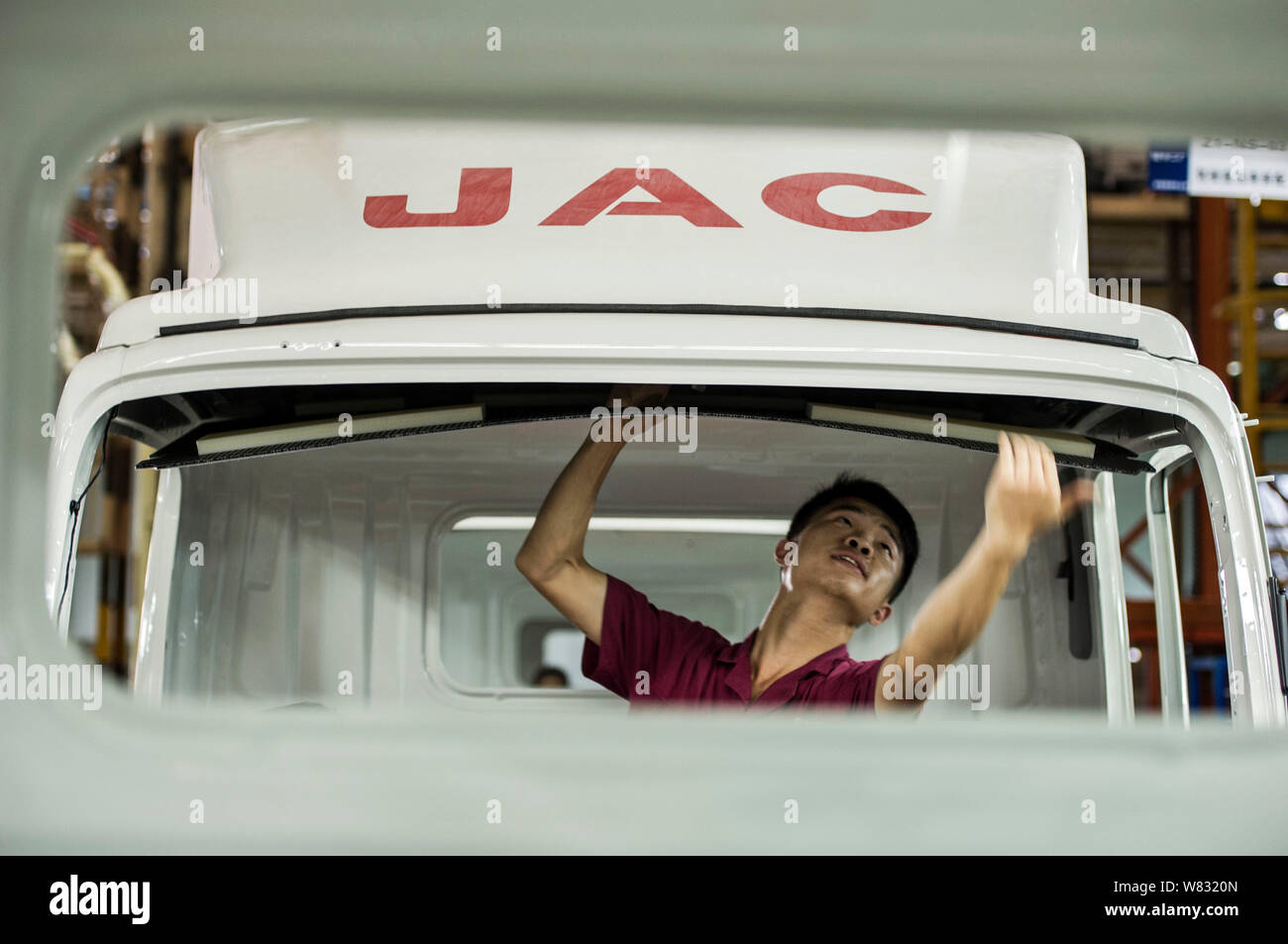 --FILE--A Chinese worker assembles a truck on the assembly line at an ...