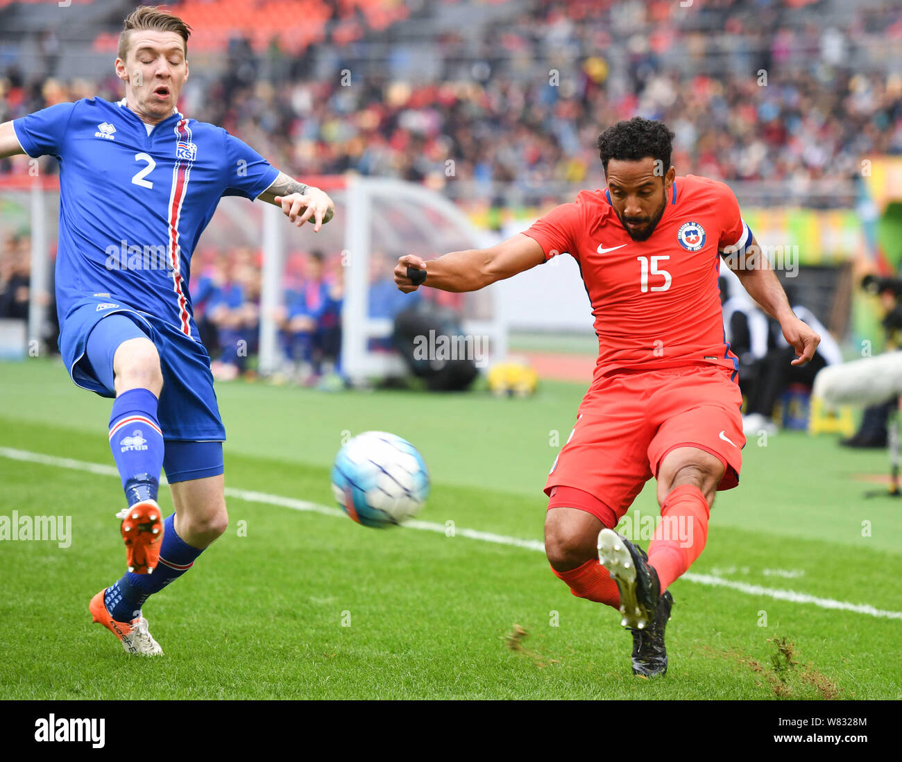 Jean Beausejour of Chile, right, challenges a player of Iceland in their final match during the 2017 Gree China Cup International Football Championshi Stock Photo