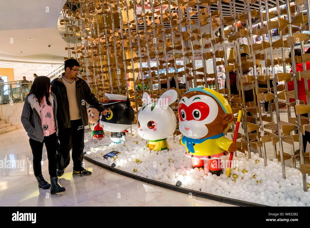 Visitors look at sculptures from Chinese cartoons at China's first ...