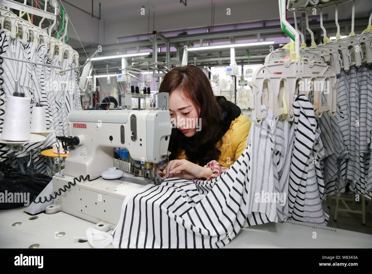 FILE&ndash;A female Chinese worker sews clothes to be exported to Japan 