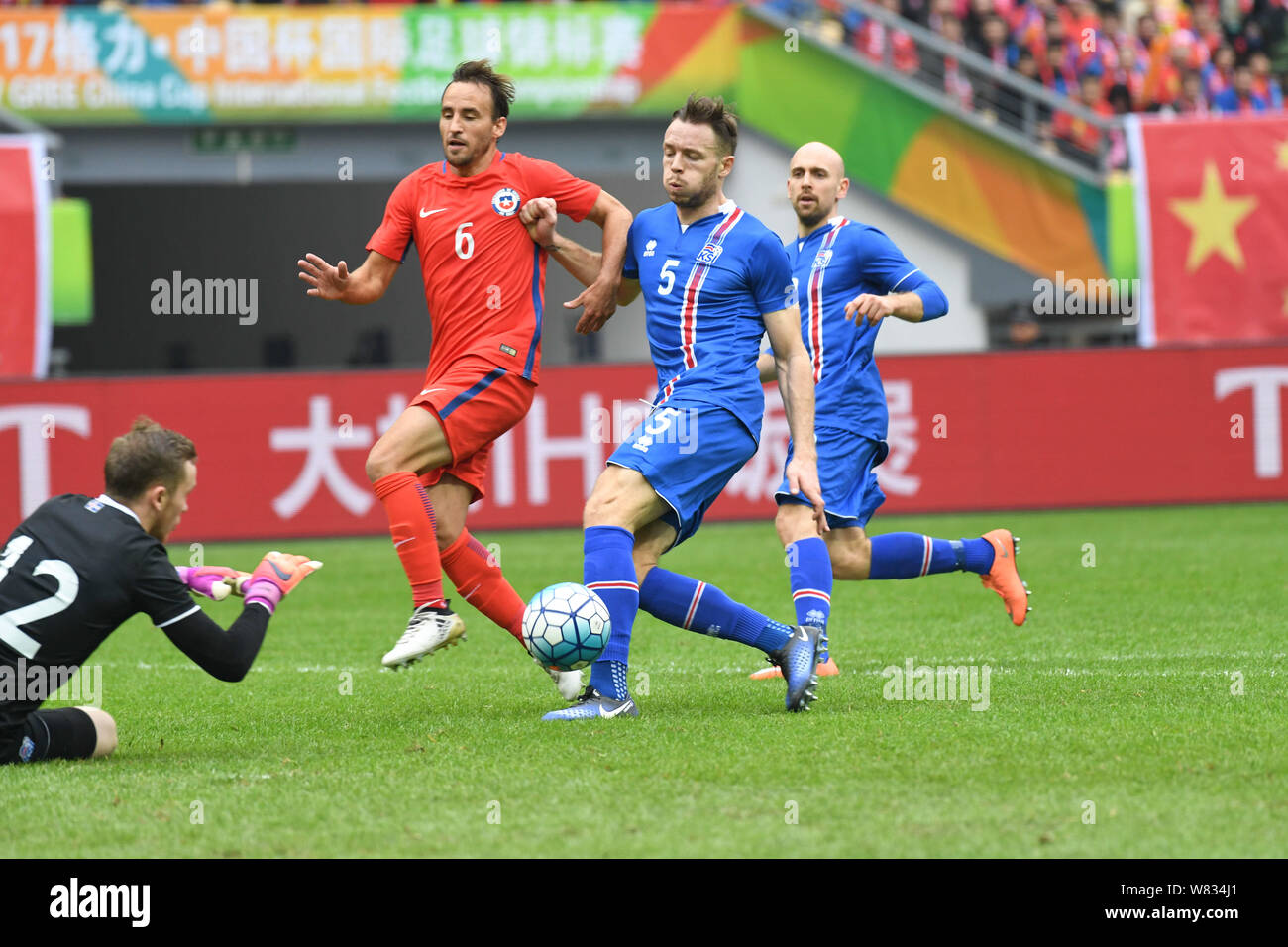 Jose Pedro Fuenzalida of Chile, second left, challenges players of Iceland in their final match during the 2017 Gree China Cup International Football Stock Photo