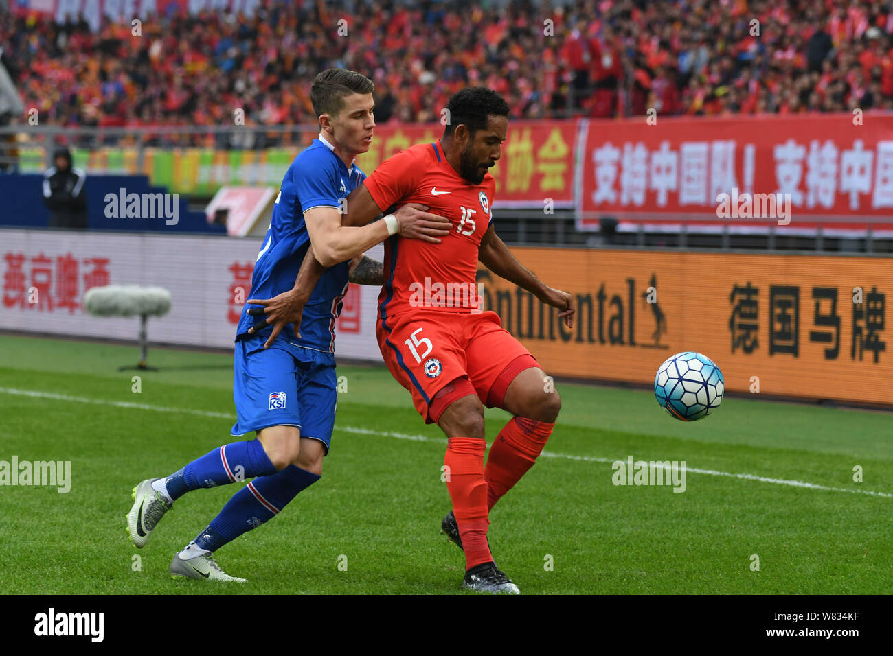 Jean Beausejour of Chile, right, challenges a player of Iceland in their final match during the 2017 Gree China Cup International Football Championshi Stock Photo