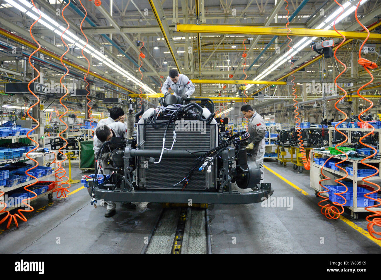 --FILE--Chinese workers assemble a truck on the assembly line at an ...