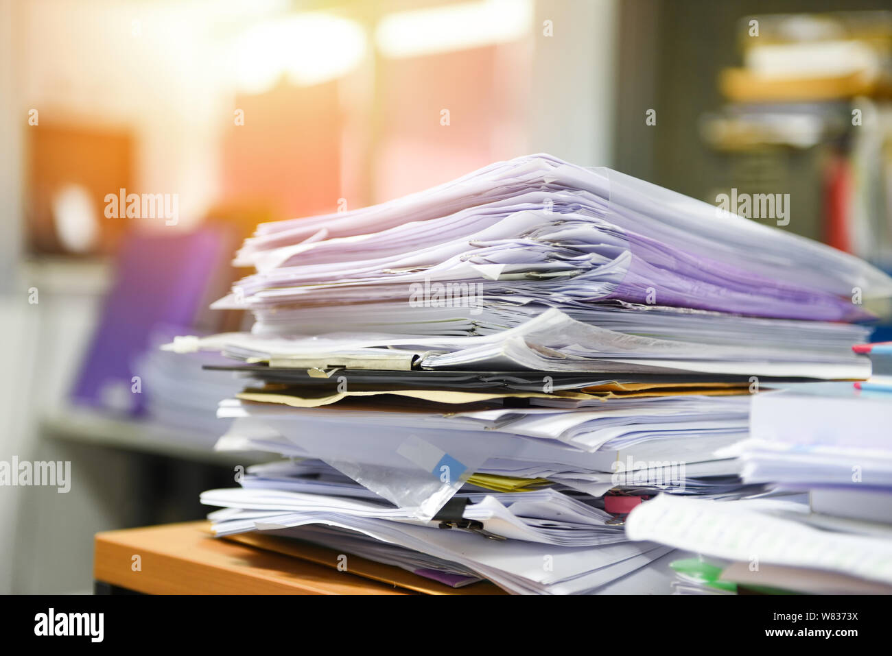 Lot of work document file working stacks of paper files searching information on work desk office / business report papers piles unfinished on the tab Stock Photo