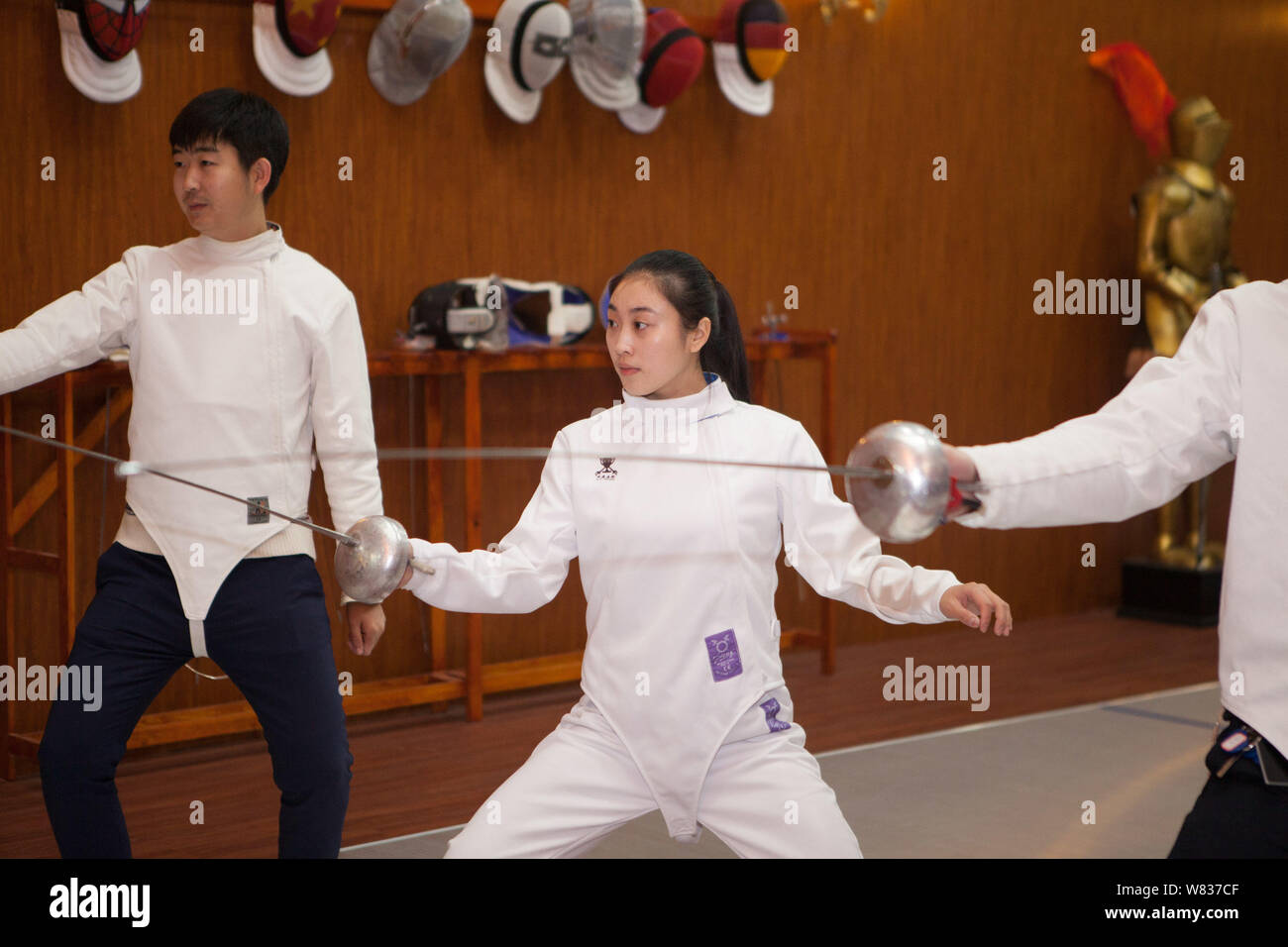 Chinese fencing trainer Mou Jiahui, center, instructs fencing skills to learners at her training center in Jilin city, northeast China's Jilin provinc Stock Photo