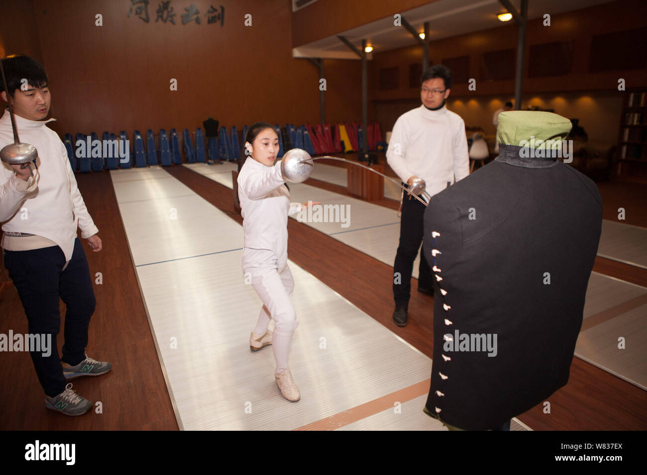 Chinese fencing trainer Mou Jiahui, center, instructs fencing skills to learners at her training center in Jilin city, northeast China's Jilin provinc Stock Photo