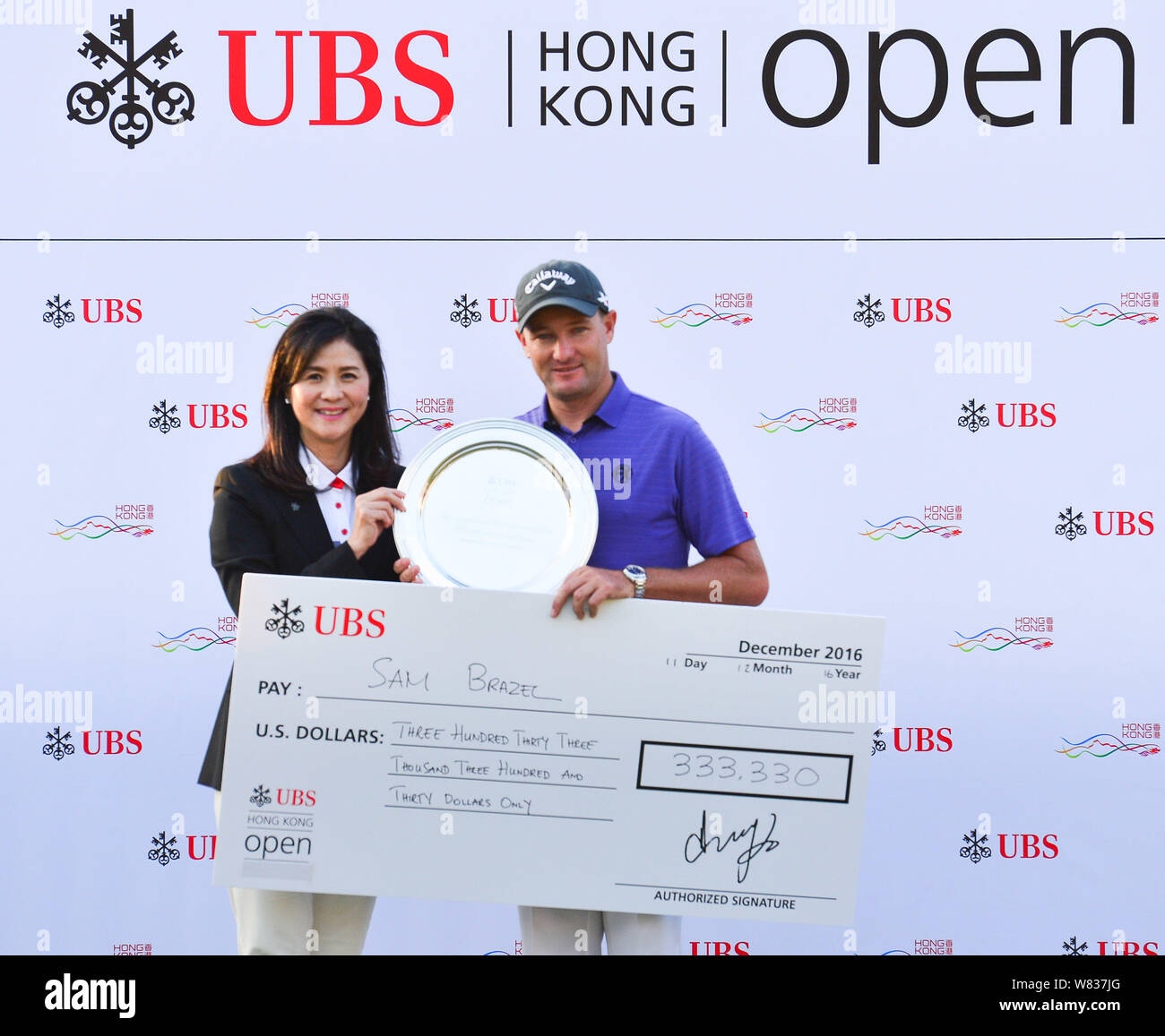 Australian golfer Sam Brazel, right, poses with his trophy after winning the UBS Hong Kong Open 2016 at The Hong Kong Golf Club Fanling in Hong Kong, Stock Photo