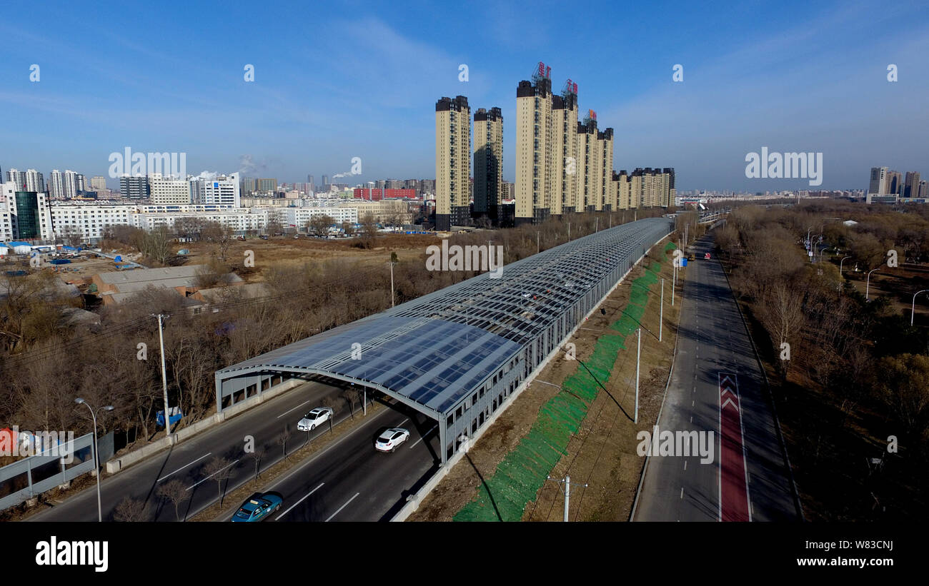 Aerial view of an elevated road fully covered by noise-reduction shelters in Shenyang city, northeast China's Liaoning province, 5 December 2016.    A Stock Photo