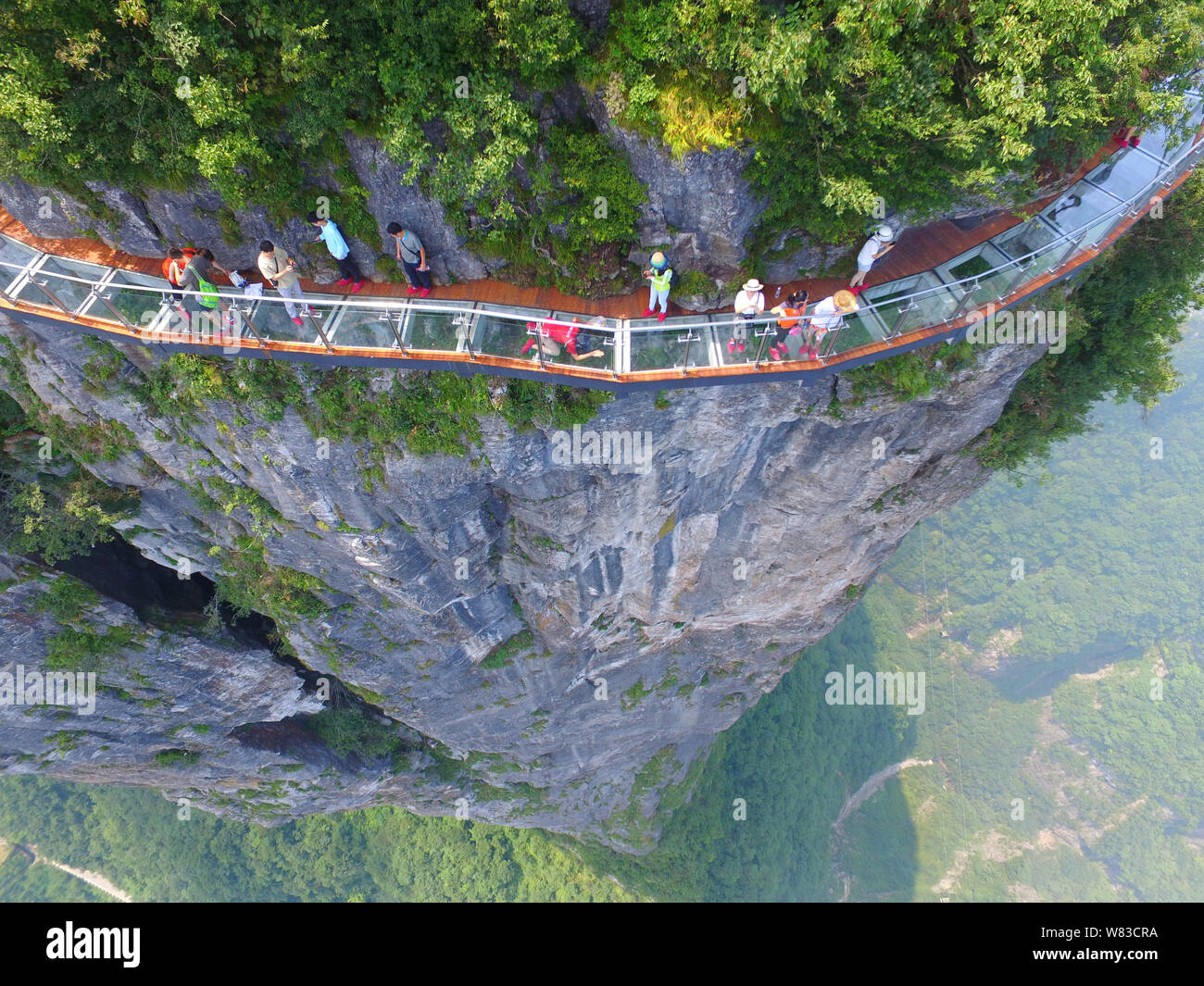 Aerial view of the 100-meter-long and 1.6-meter-wide glass skywalk on the cliff of Tianmen Mountain (or Tianmenshan Mountain) in Zhangjiajie National Stock Photo