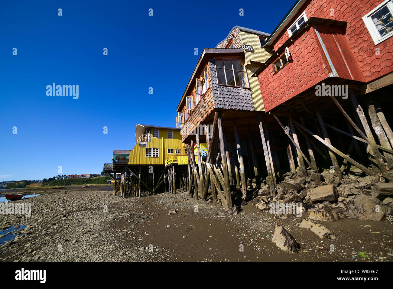 CASTRO, CHILE - FEBRUARY 6, 2016: Palafitos, traditional wooden stilt houses at low tide along the Gamboa River in Castro, Chiloe Archipelago, Chile Stock Photo