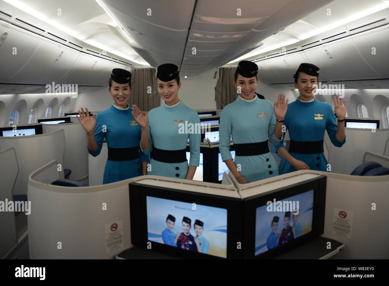 Chinese air hostesses pose in the business class of the first Boeing 787-9 Dreamliner of Xiamen Airlines at the Xiamen Gaoqi International Airport in Stock Photo