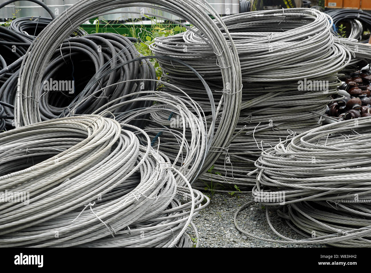 Photo of rolls of metal or steel cables used for electric poles at an industrial yard Stock Photo