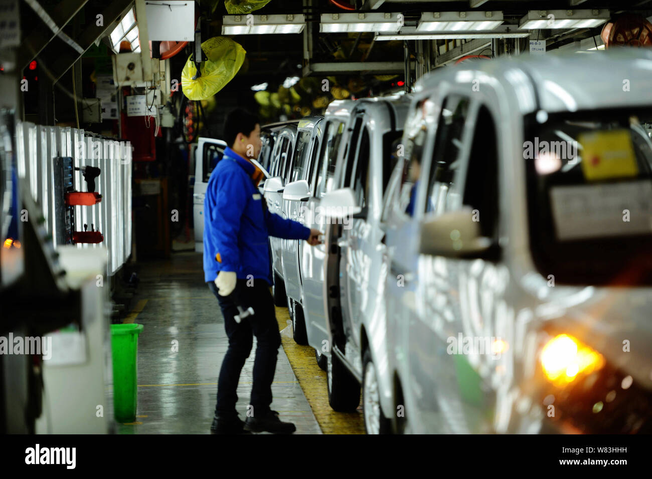 --FILE--A Chinese worker assembles cars on the assembly line at an auto ...