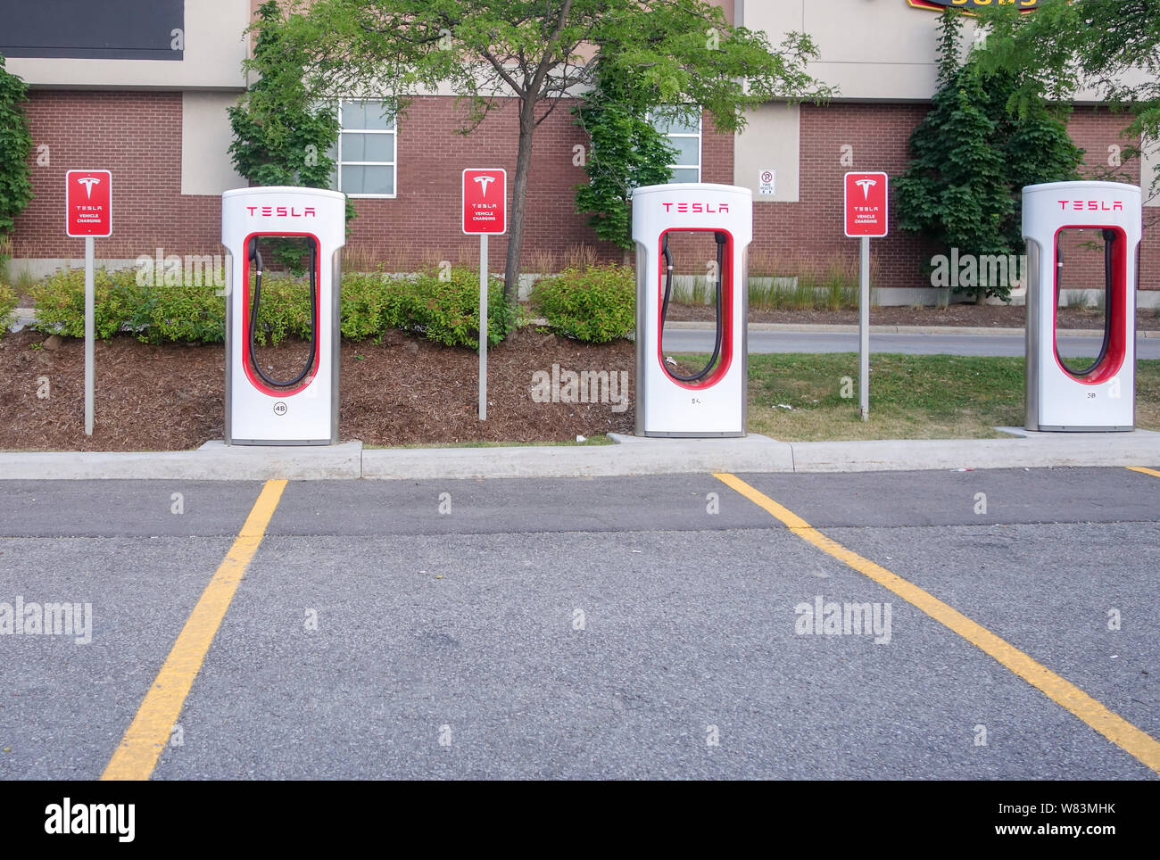 Three Tesla charging stations for electric cars in Barrie Ontario Canada Stock Photo