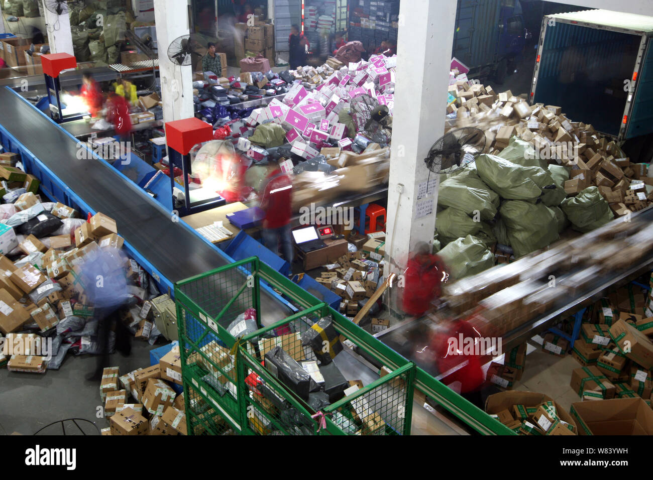Chinese workers sort piles of parcels, most of which are from Singles