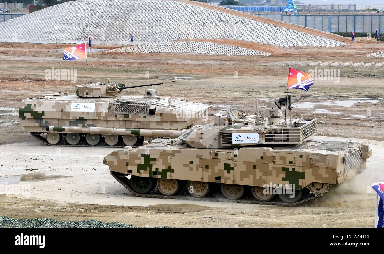 A VT4 tank, also known as the MBT3000, and a VN12 infantry fighting vehicle perform during 11th China International Aviation and Aerospace Exhibition, Stock Photo