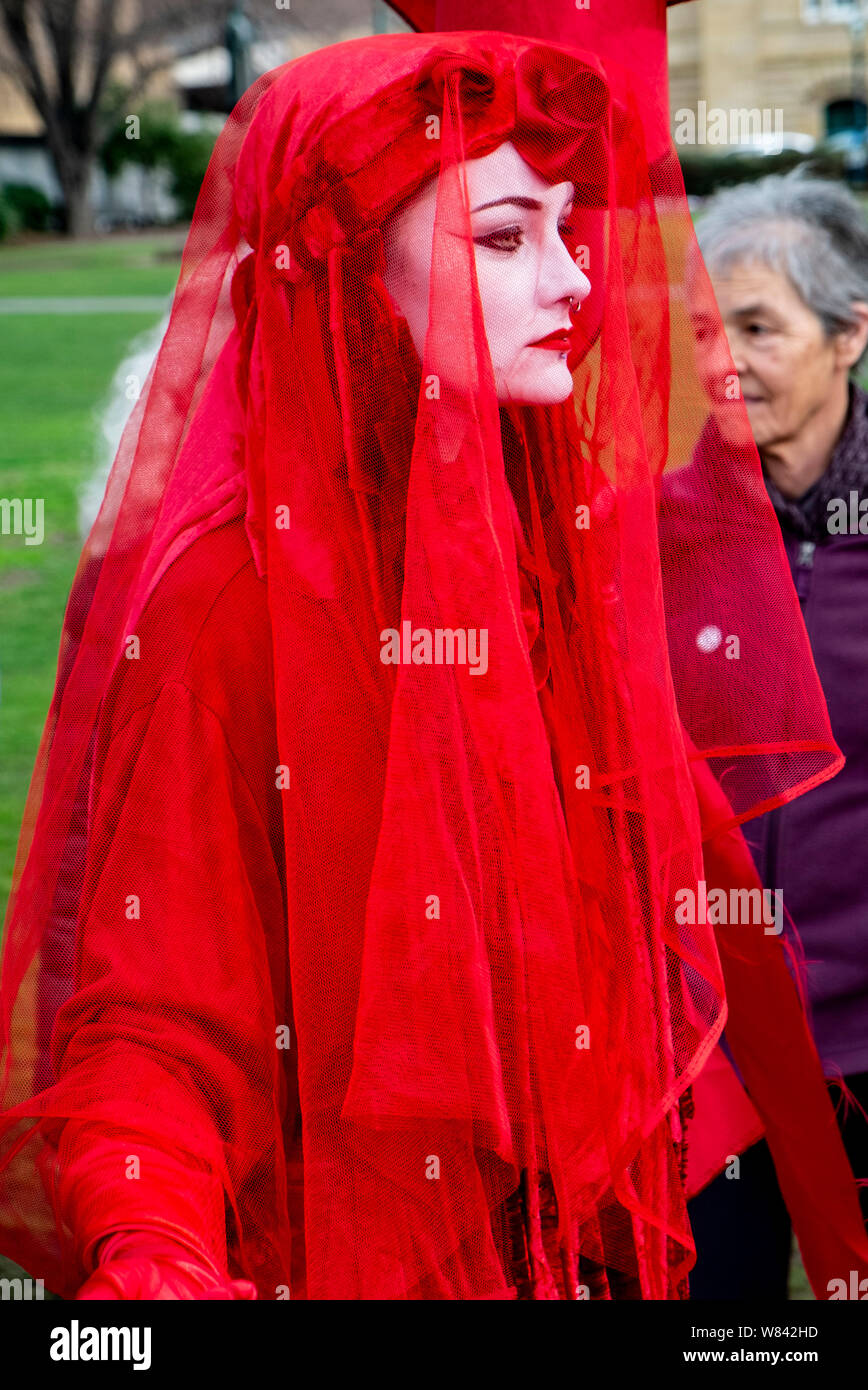Members of the performance group known as the Red Brigade at The Extinction Rebellion protest against climate change inaction, outside the Tasmanian Parliament in Hobart, today (Thursday, August 8, 2019) Stock Photo