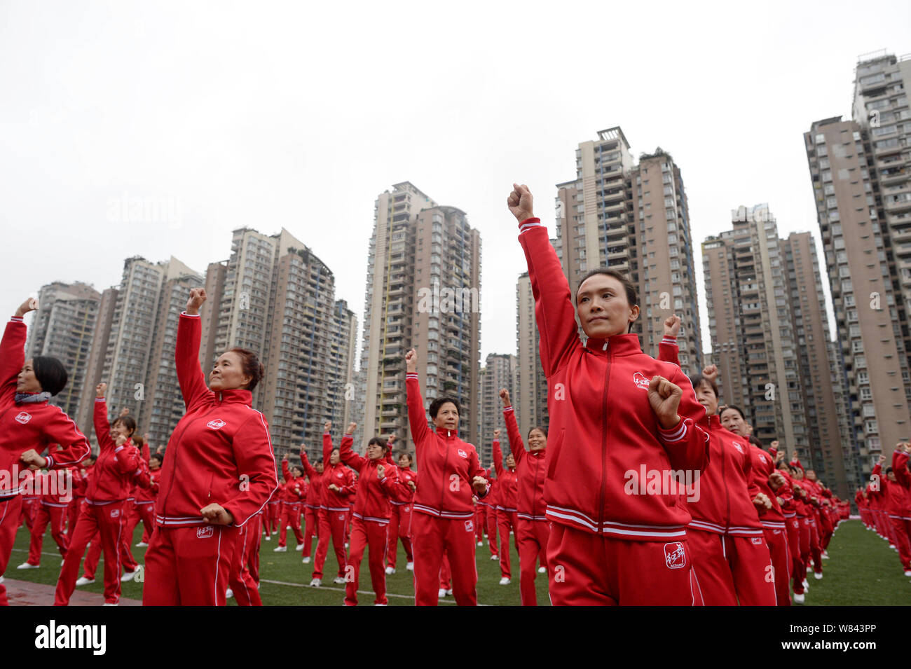 Local Chinese residents perform square dance during an attempt to set a new Guinness World Record for the biggest choreographed square dance in Chongq Stock Photo