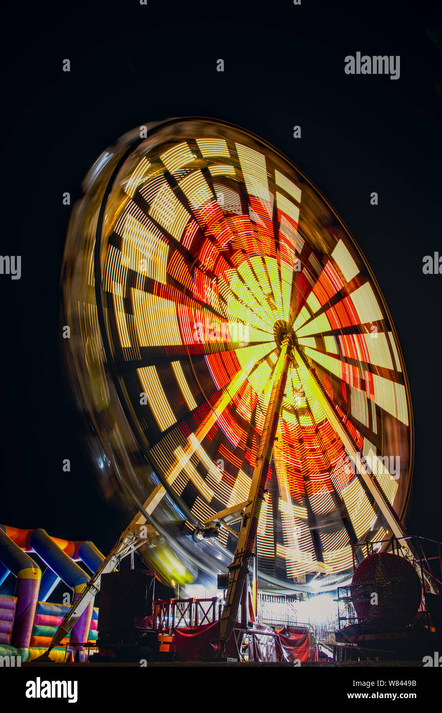Ferris wheel with lights at night timelapse Stock Photo