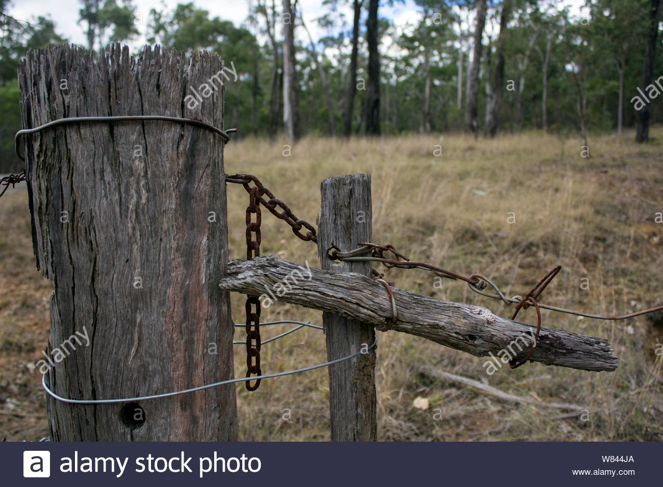 Weathered Old Wooden Fence Post With Barbed Wire Stock Photos & Weathered Old Wooden Fence Post