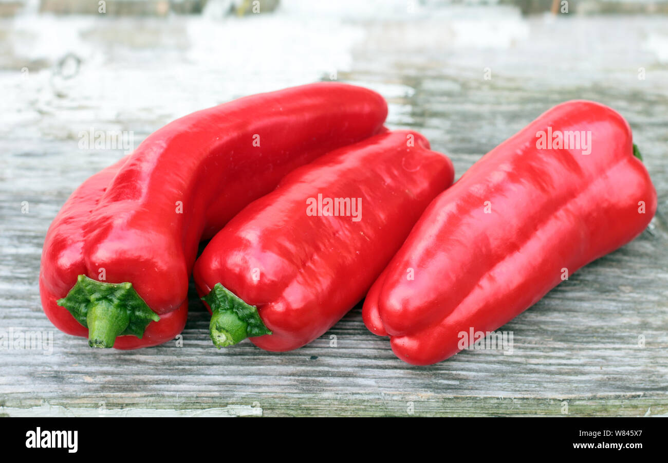 sweet red pepper on rustic table Stock Photo - Alamy