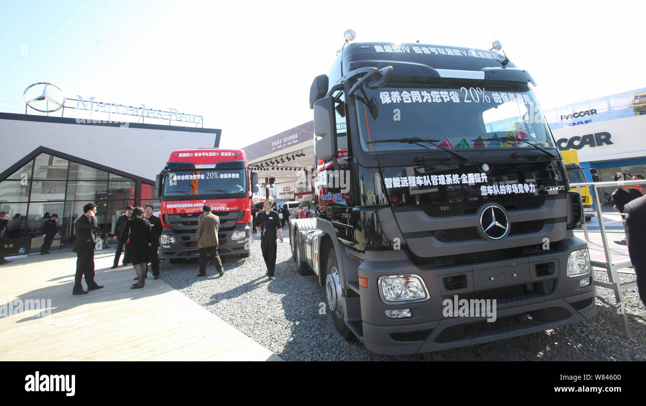 --FILE--Visitors look at Mercedes-Benz Actros heavy trucks of Daimler on display during the 12th Beijing International Automotive Exhibition, also kno Stock Photo