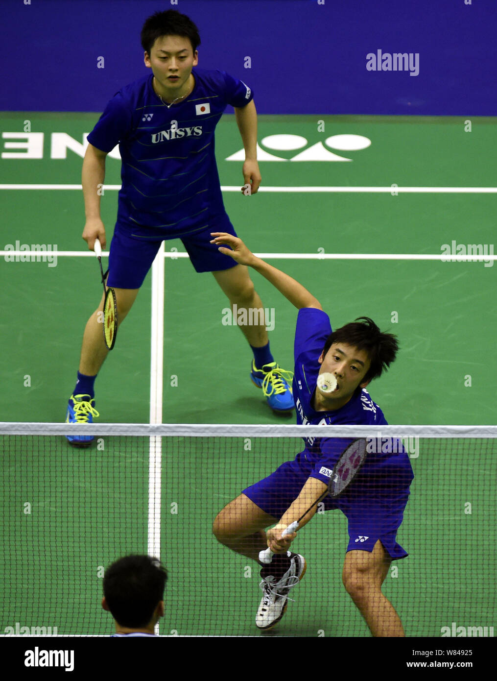 Yuki Kaneko, front, and Takuto Inoue of Japan return a shot to Lu Kai ...