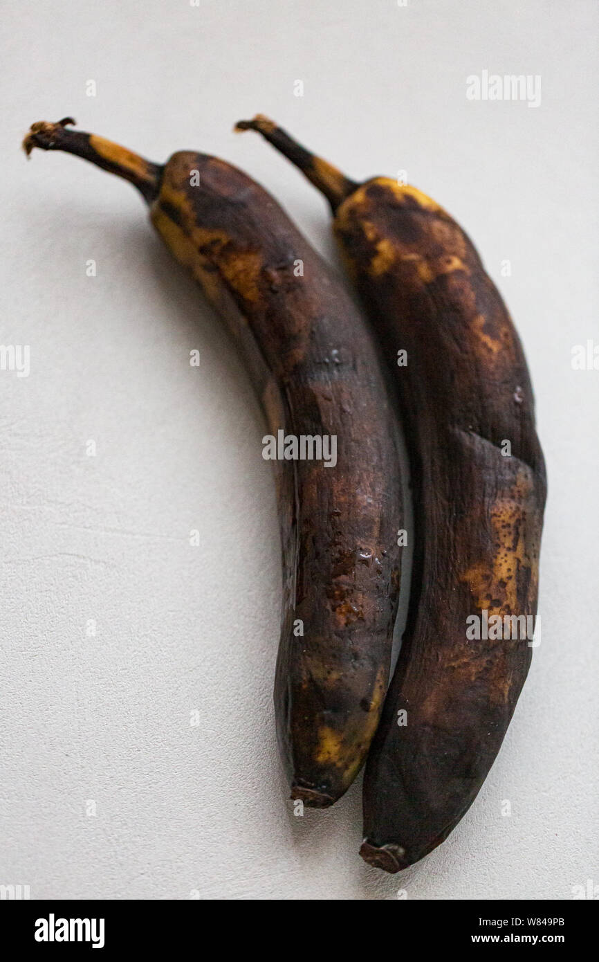 Dried unhealthy banana on white background. Trendy spoiled organic