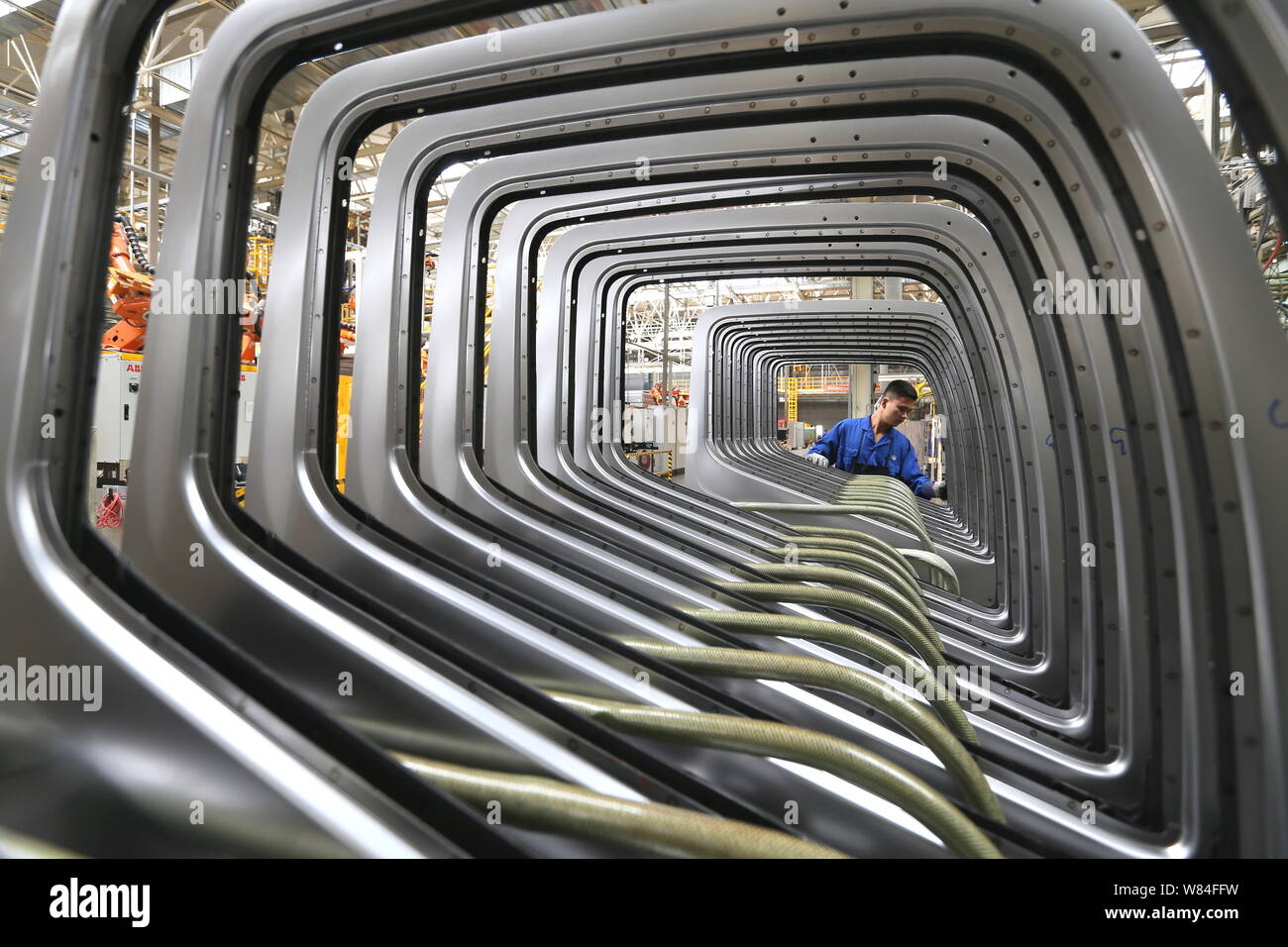 A Chinese worker lines up doors of rucks at a plant of FAW in Qingdao city, east China's Shandong province, 29 September 2016.   Activity in China's m Stock Photo