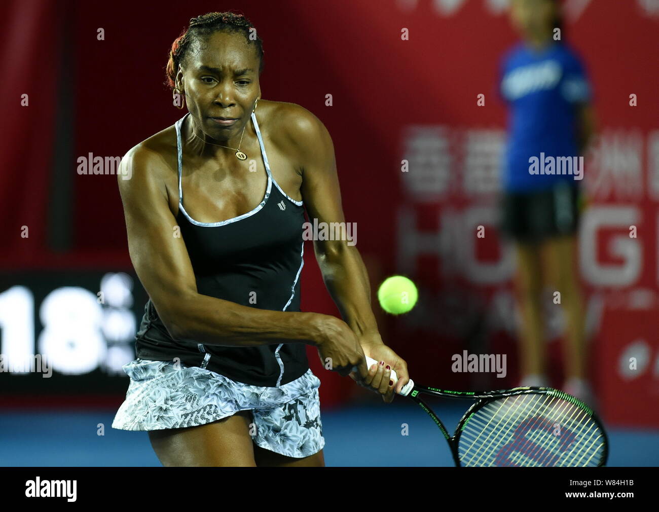 Venus Williams of the United States returns a shot to Alize of