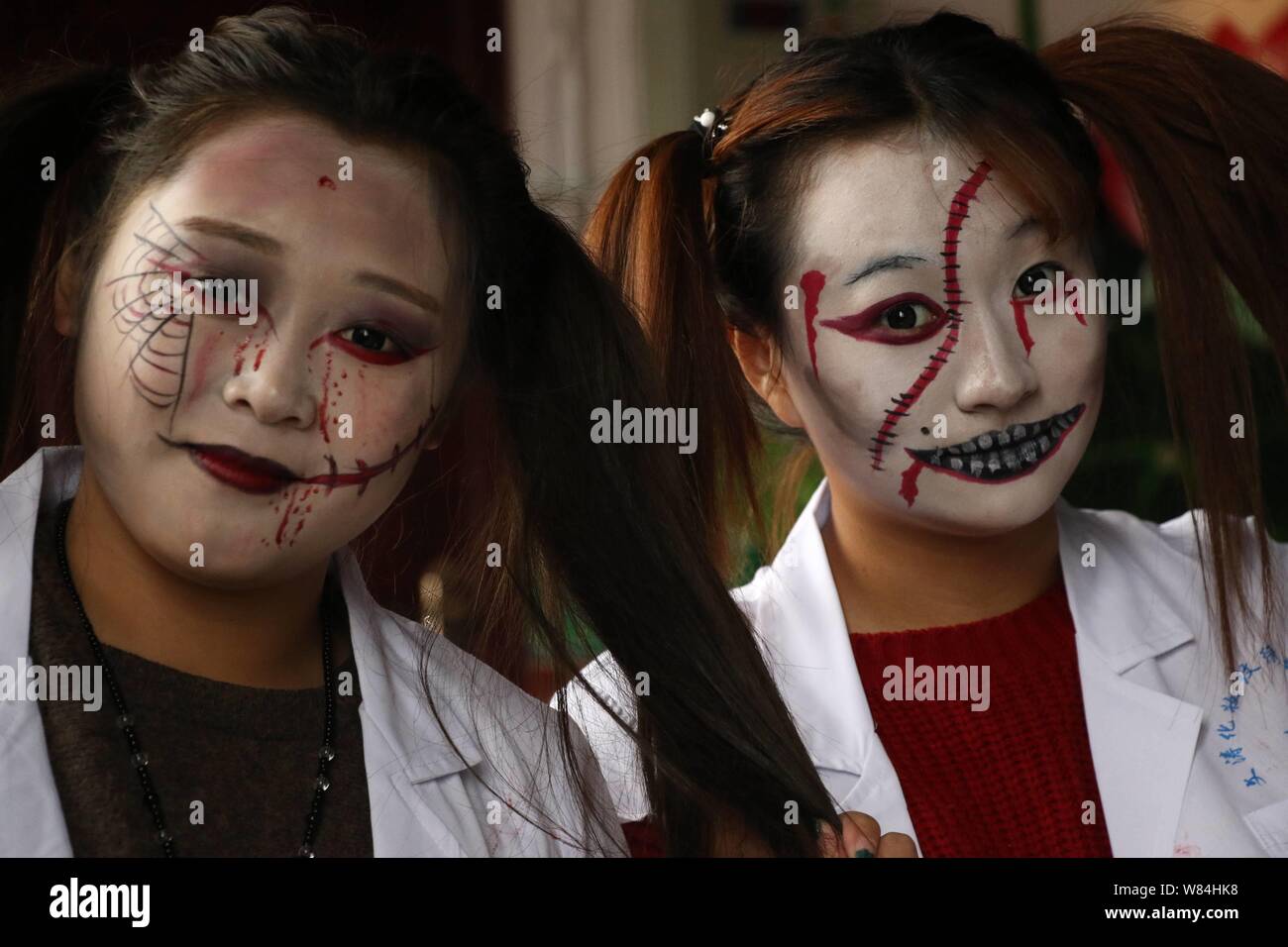 Young women with zombie makeups pose during a gathering to celebrate Halloween at a barbecue restaurant in Binzhou city, east China's Shandong provinc Stock Photo