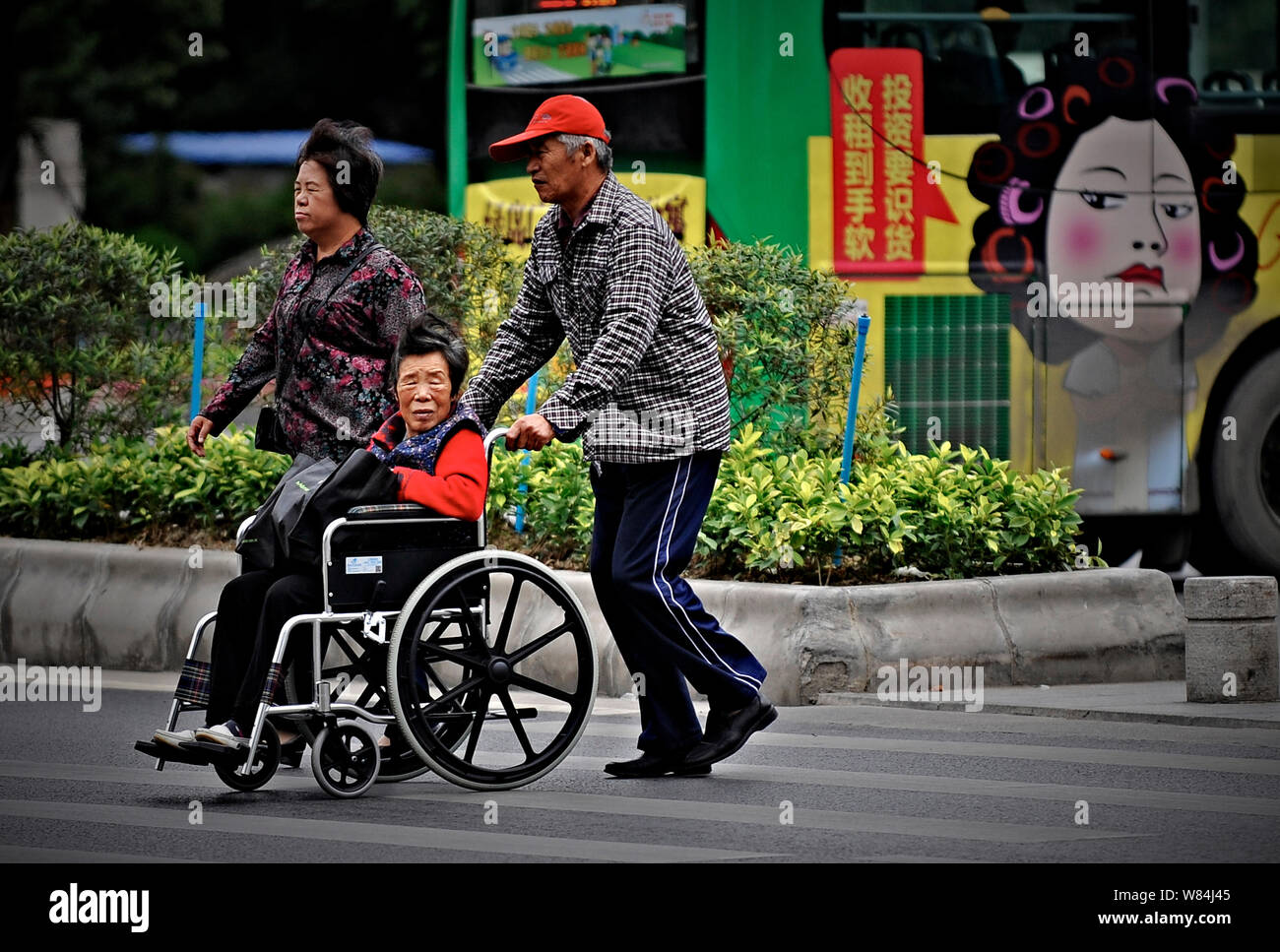 FILEAn elderly Chinese woman sitting on a wheelchair is pushed by