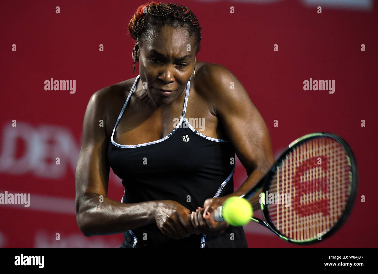 Venus Williams of the United States returns a shot to Alize of